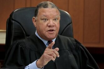 Boston Municipal Court Judge Mark Summerville addresses the court room, while holding an U.S. Immigration and Customs Enforcement agent in contempt after he detained a suspect while he was on trial, Monday, March 31, 2025, in Boston. (Pat Greenhouse/The Boston Globe via AP)