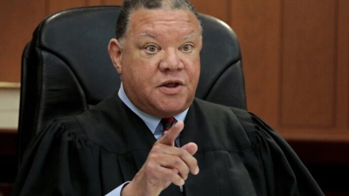 Boston Municipal Court Judge Mark Summerville addresses the court room, while holding an U.S. Immigration and Customs Enforcement agent in contempt after he detained a suspect while he was on trial, Monday, March 31, 2025, in Boston. (Pat Greenhouse/The Boston Globe via AP)